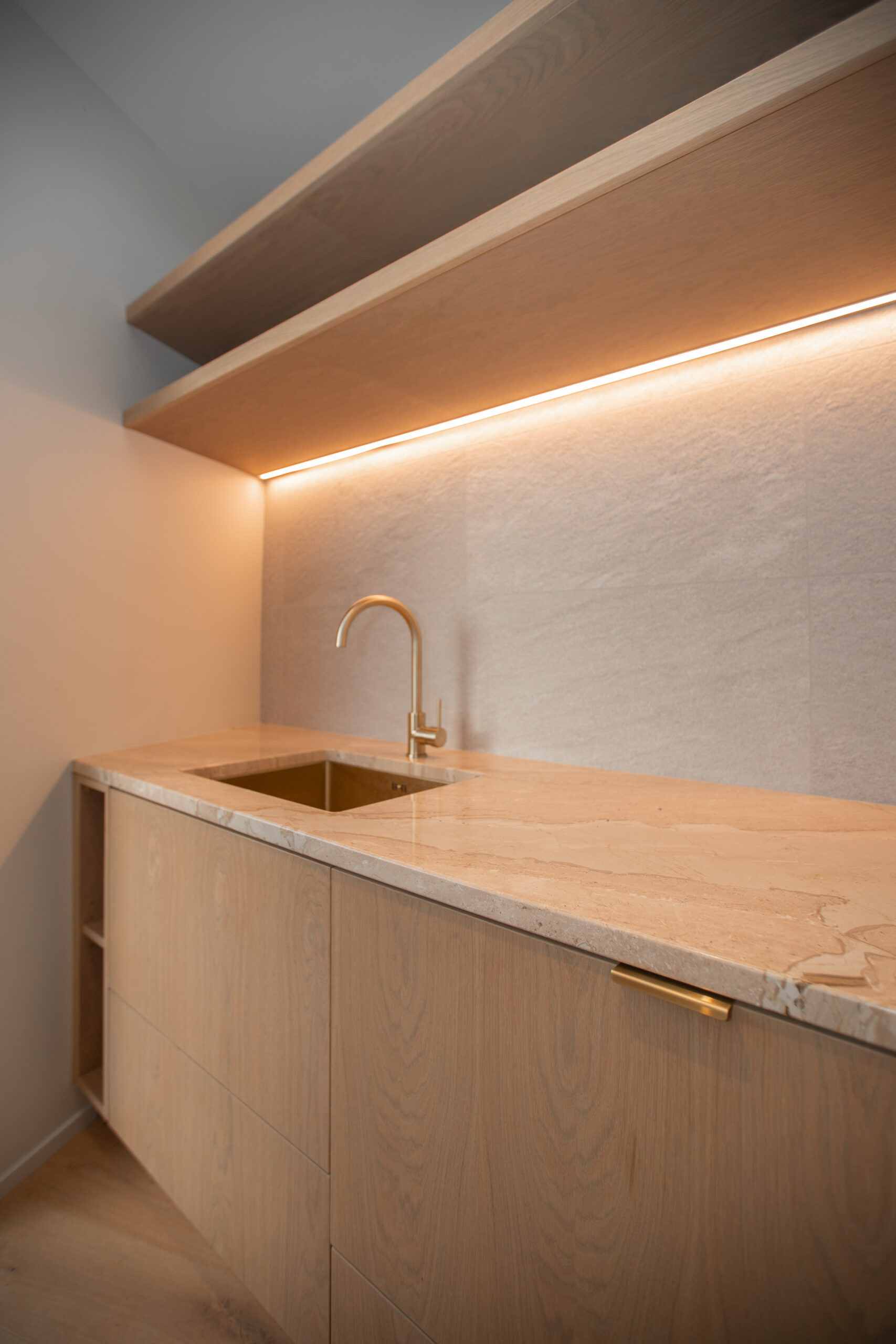 Laundry sink completed with rail lighting, and marble bench top